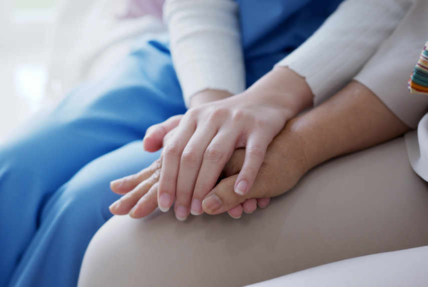 Hospice-nurse-holding-the-hand-of-patient-receiving-nursing-care
